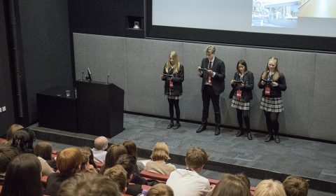 a group of people standing in front of a crowd
