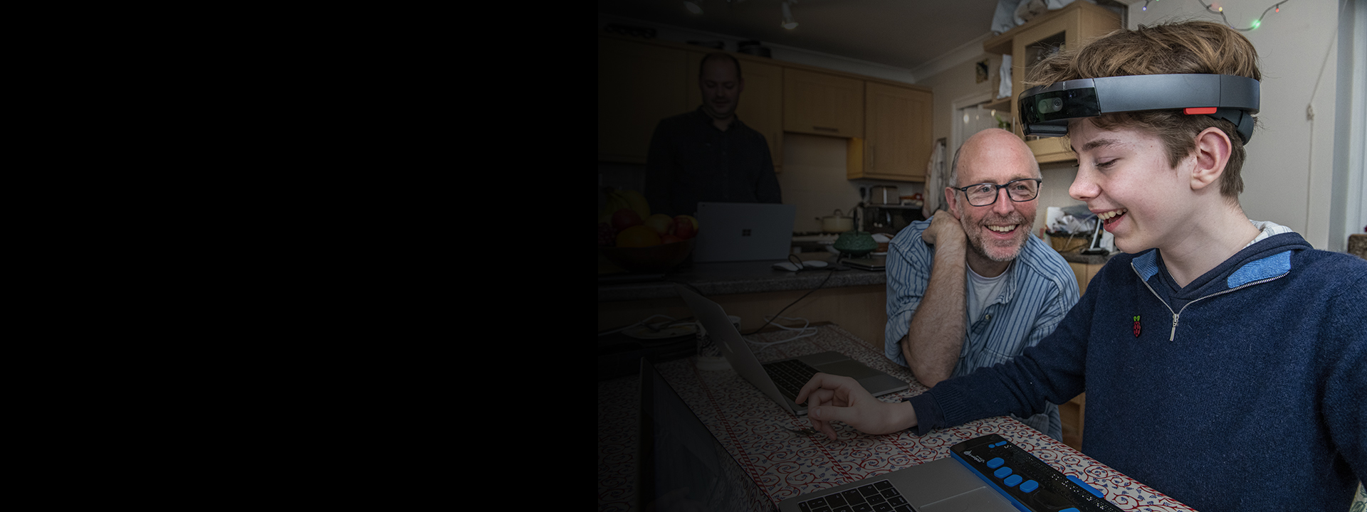 Theo, right, a 12-year-old boy who is blind, interacts with Microsoft senior research software development engineers Tim Regan, middle, and Martin Grayson, left, during user testing of the Project Tokyo system.