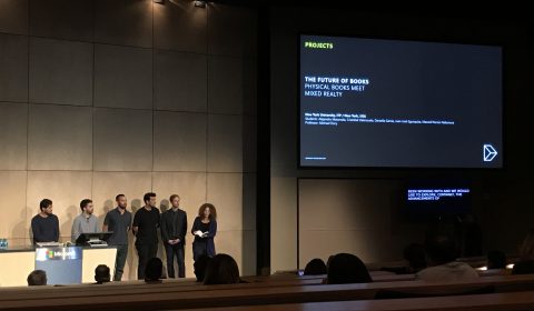 a group of people standing in front of a television