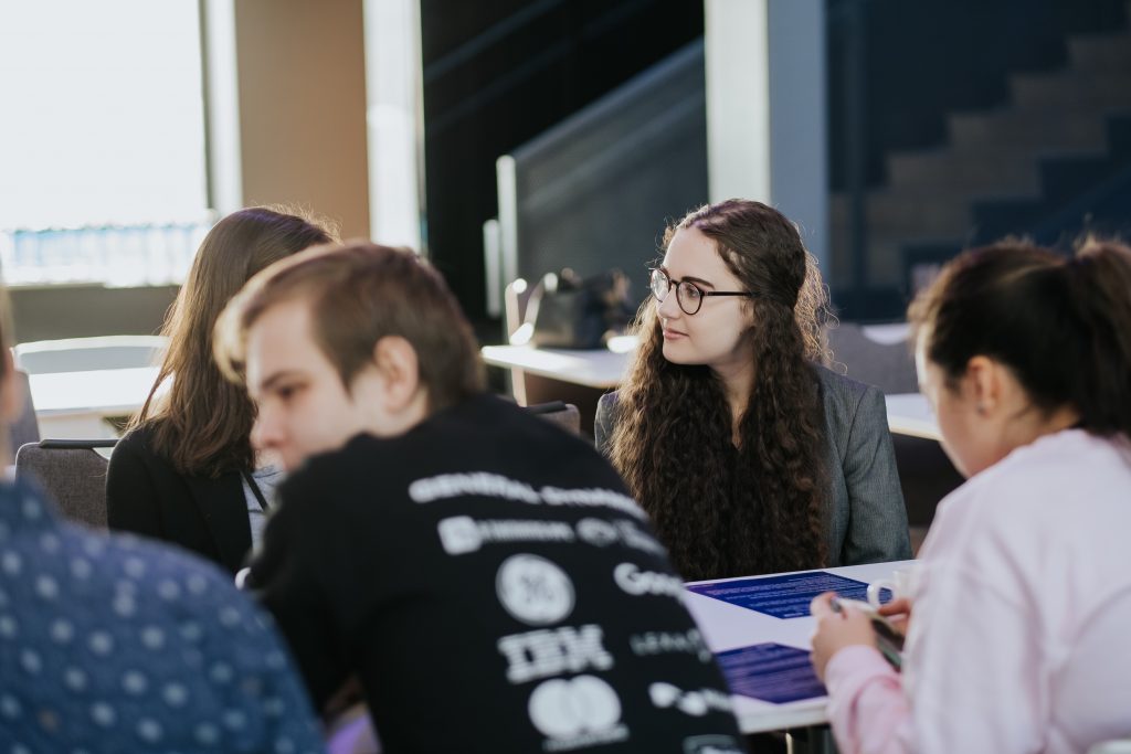 a group of people sitting in front of a crowd