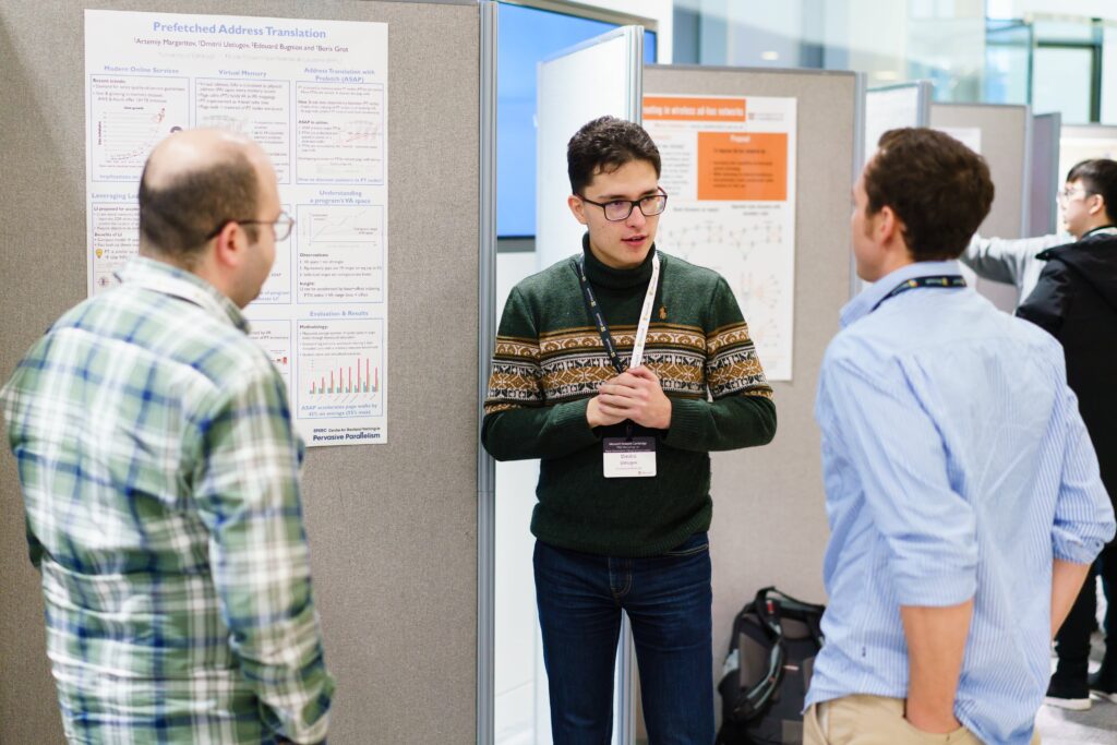 a group of people standing in front of a computer
