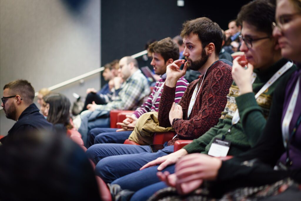 a group of people sitting in front of a crowd