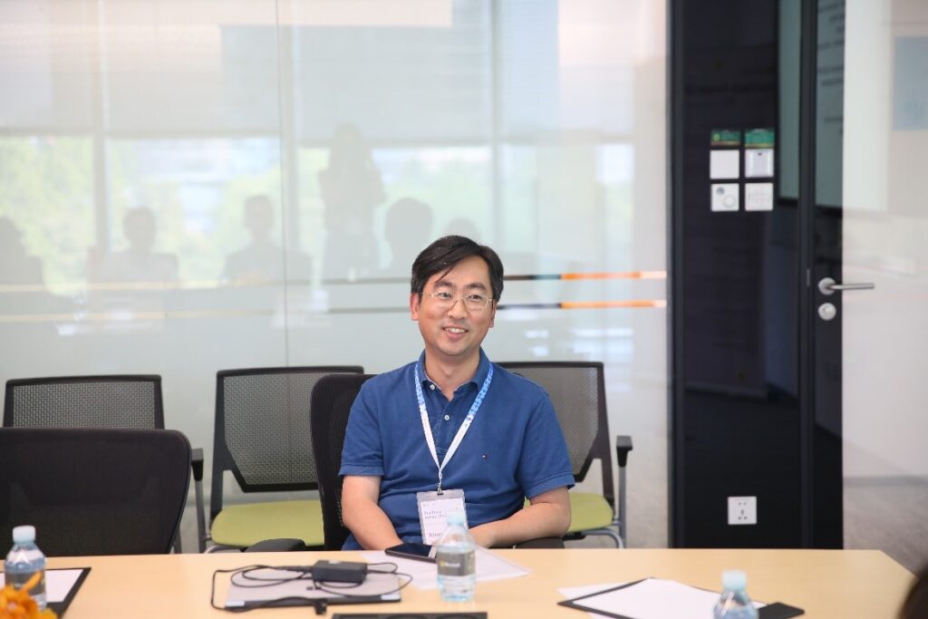a man sitting at a table using a laptop