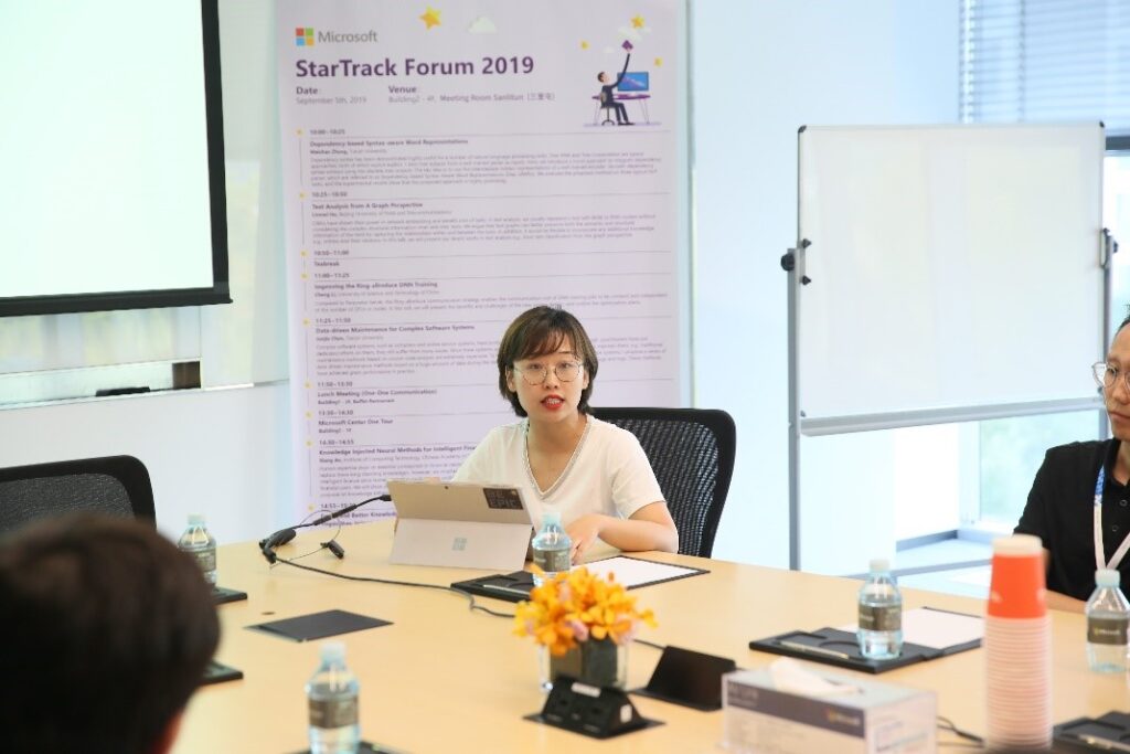 a group of people sitting at a desk
