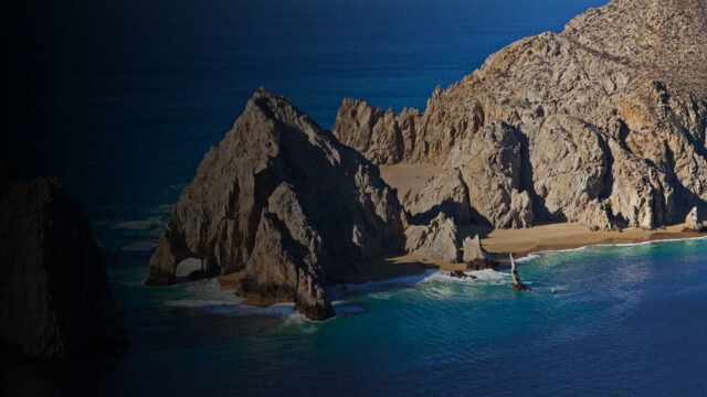 a rocky island in the middle of a body of water