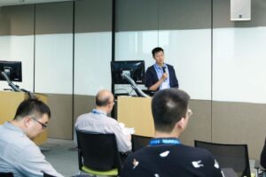 a group of people sitting at a desk