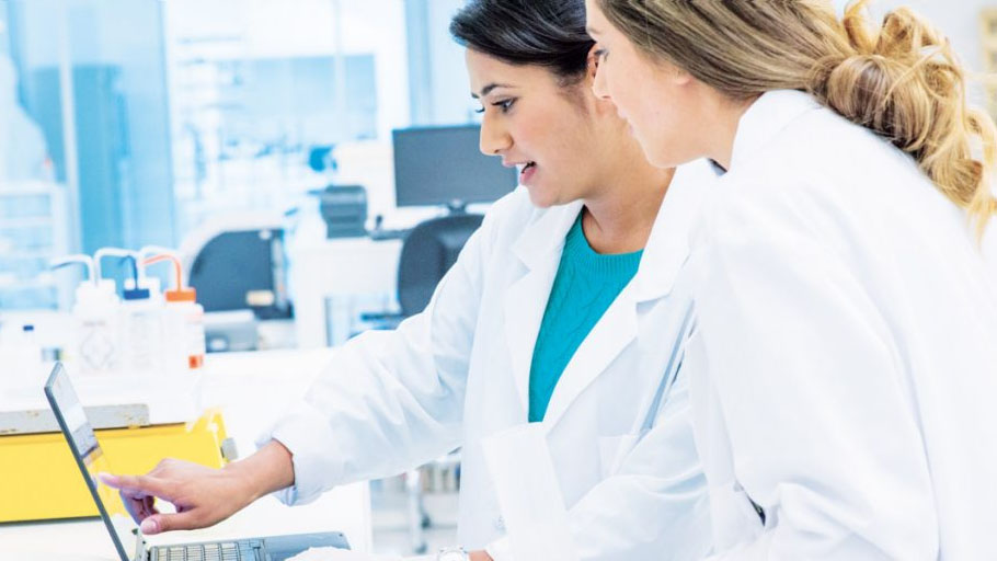 Societal resilience (information resilience) - two female scientists reviewing a computer onitor