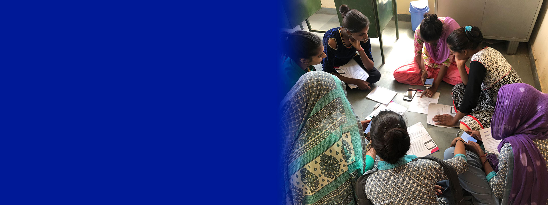 SCAI header - photo a a group of women sitting on the floor working on their phones