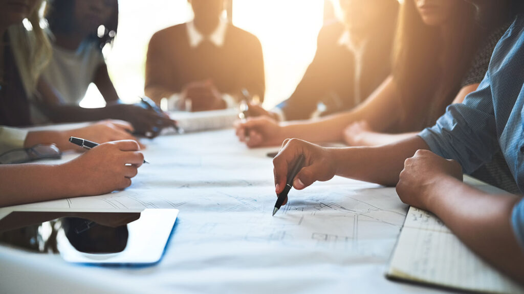 societal individual institutional image: group of people working around a table