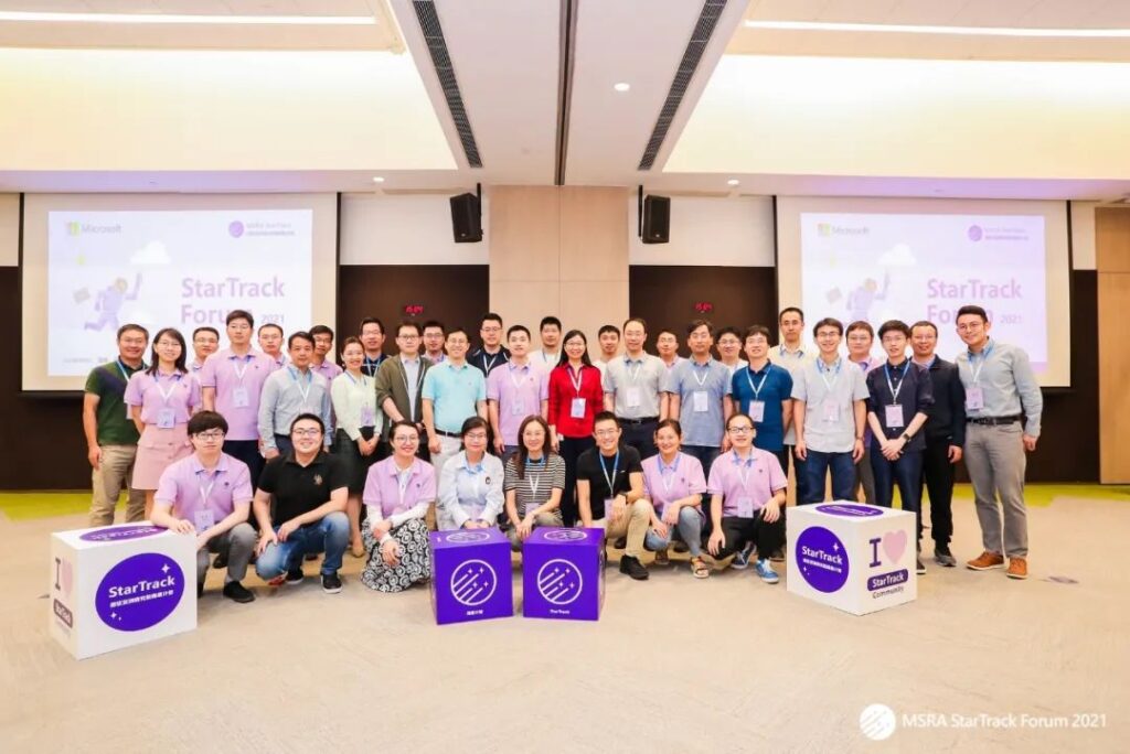 a group of people standing in front of a crowd posing for the camera