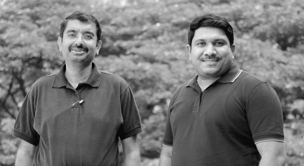 a couple of people that are standing in the grass