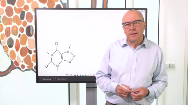 Christopher Bishop standing in front of a whiteboard