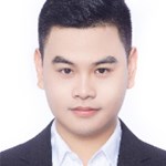 a young man wearing a suit and tie smiling at the camera