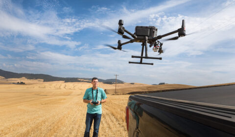 Andrew Nelson launches a drone from the back of a pickup truck (Photo by Dan DeLong for Microsoft)