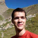 a man standing in front of a mountain