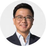 Tie-Yan Liu wearing a suit and tie smiling at the camera