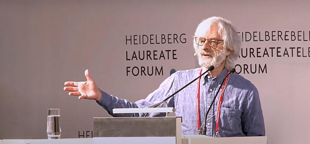 Leslie Lamport giving a talk on stage