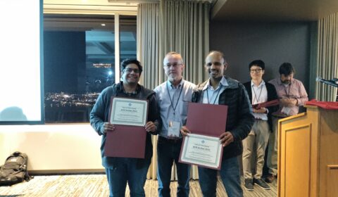 a group of people standing in front of a window