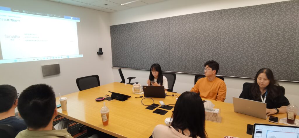 a group of people sitting at a desk in front of a computer