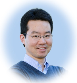 a man wearing glasses and smiling at the camera