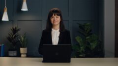 a woman standing in front of a mirror posing for the camera