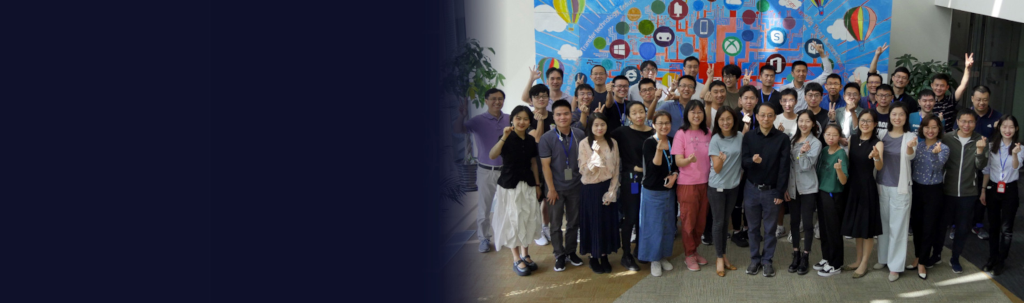 a group of people standing in front of a crowd posing for the camera