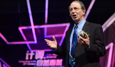 Richard Rashid standing on a stage