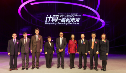 a group of people standing on a stage posing for the camera