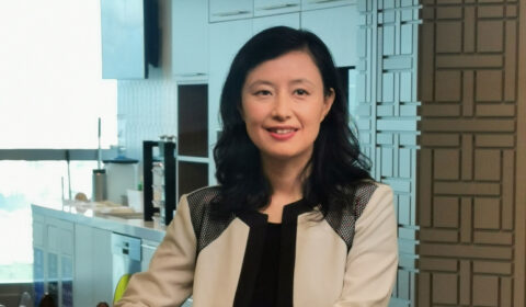 a woman standing in front of a window