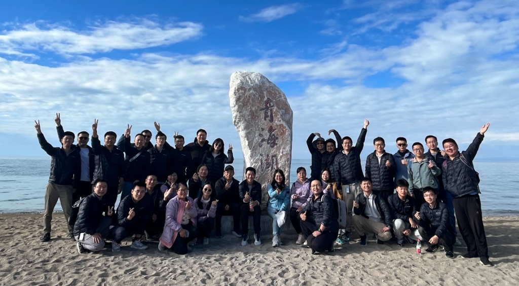 a group of people standing in front of a crowd posing for the camera