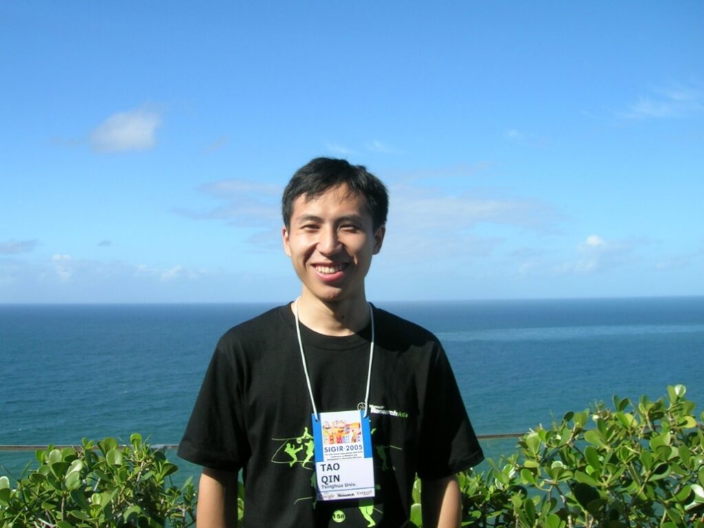 a man standing in front of a body of water