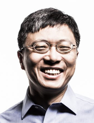 Harry Shum wearing glasses and smiling at the camera