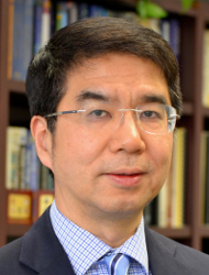 Jason Cong wearing a suit and tie smiling at the camera