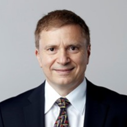 Demetri Terzopoulos wearing a suit and tie smiling at the camera