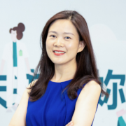 a woman holding a sign posing for the camera