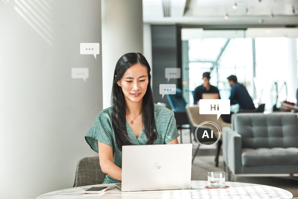 a woman sitting at a table using a laptop