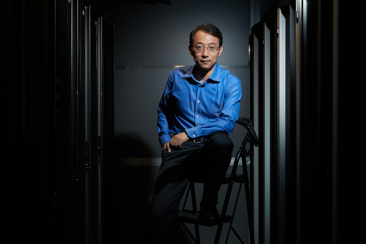 Lidong Zhou sitting in a dark room