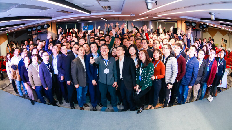 a group of people standing in front of a crowd posing for the camera