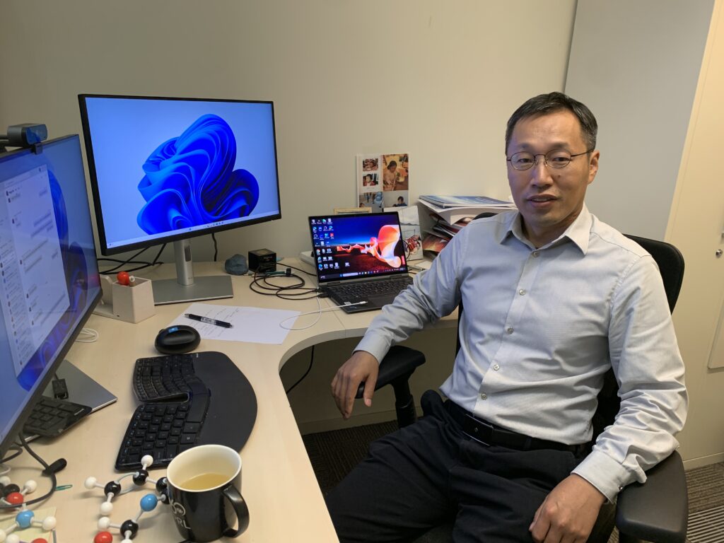 a man standing in front of a computer