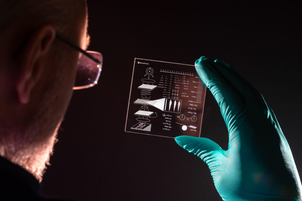 Richard studies the glass platter containing drawings explaining how to read data in glass platters.