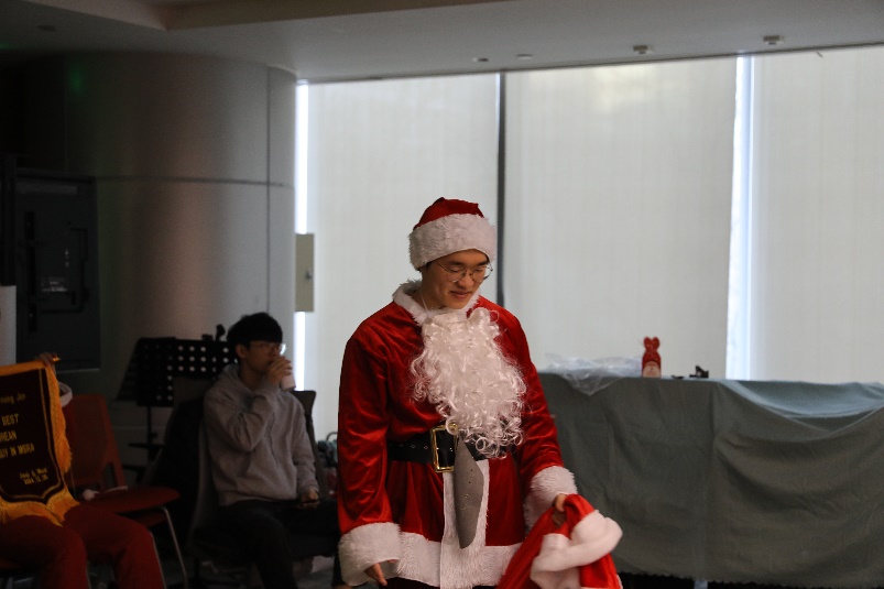CheSang plays Santa Claus at the Christmas party