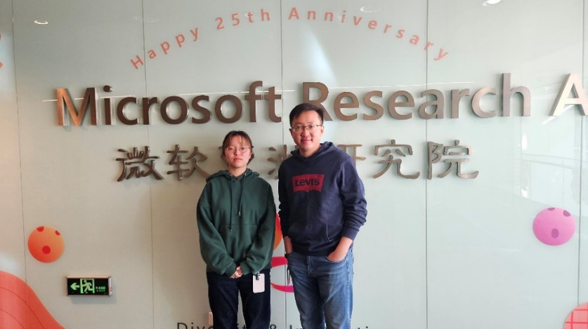 a man and a woman standing in front of a whiteboard