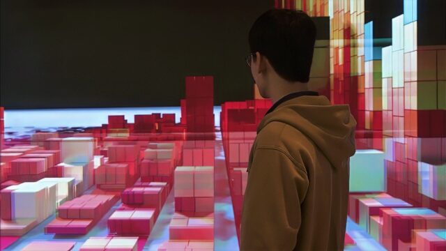 man standing and looking at a digital scene