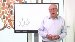 Christopher Bishop standing in front of a whiteboard