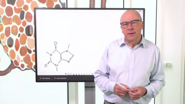 Christopher Bishop standing in front of a whiteboard