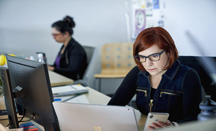 Image of an office worker at her desk.