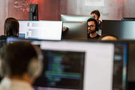 Image of a worker behind his desktop PC.