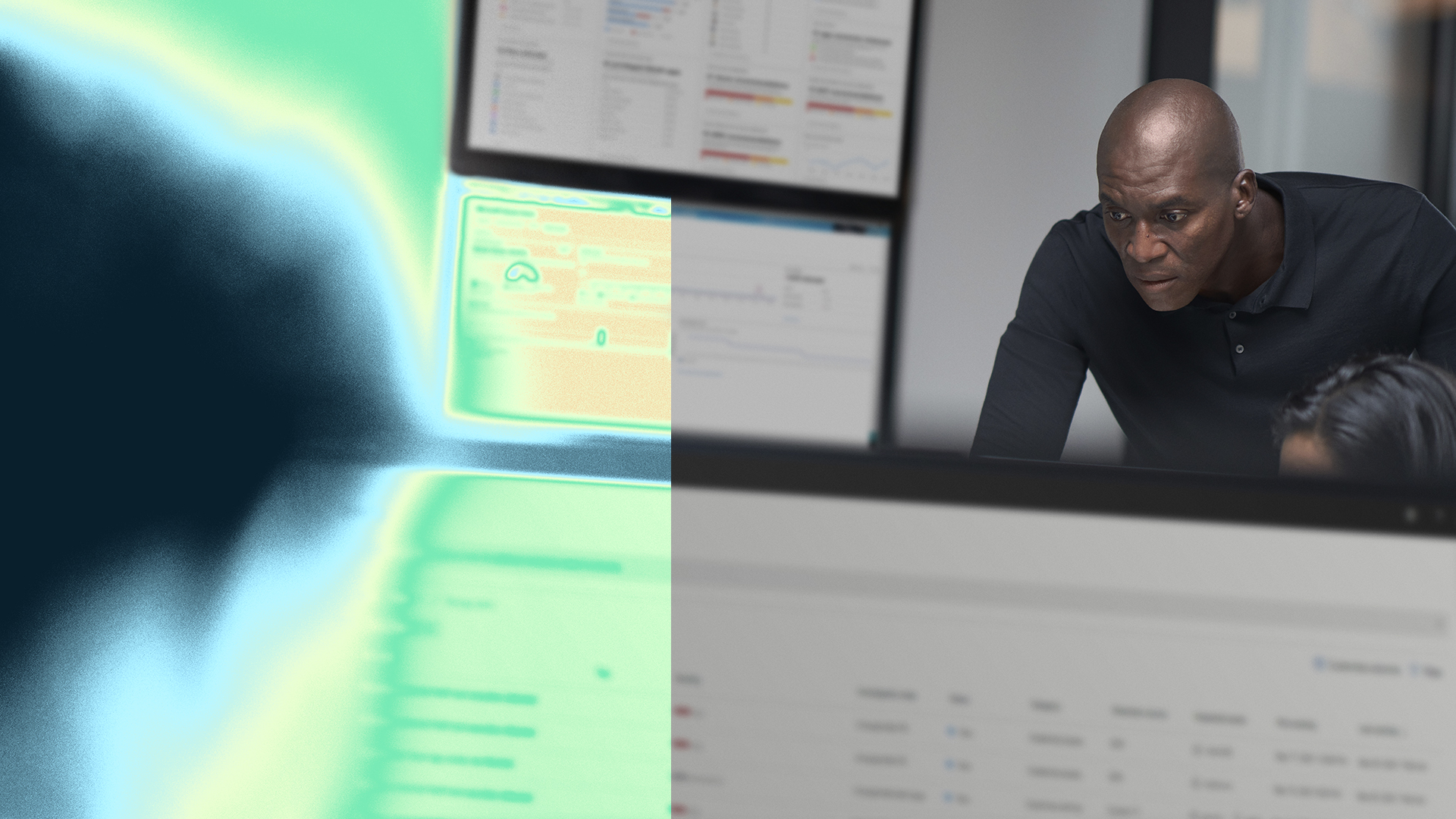 A man sitting in front of a computer screen