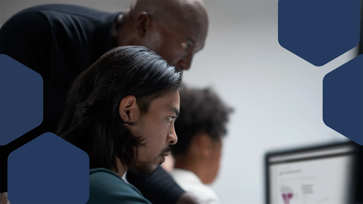 A group of people looking at a computer screen