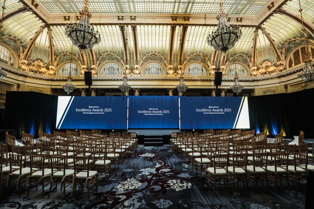 A room with chairs and a large screen